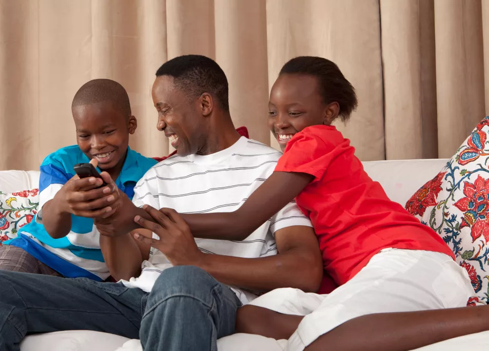 Dad and children fighting over a TV remote 