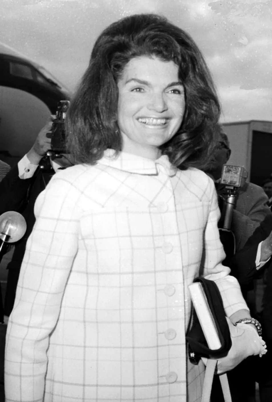 Mrs Jacqueline Kennedy smiles as she leaves the plane on arrival at London Airport from her Spanish visit.