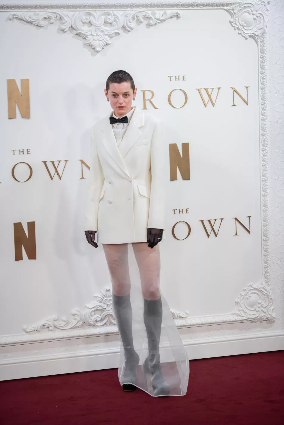 Corrin wears tuxedo jacket and sheer skirt on red carpet