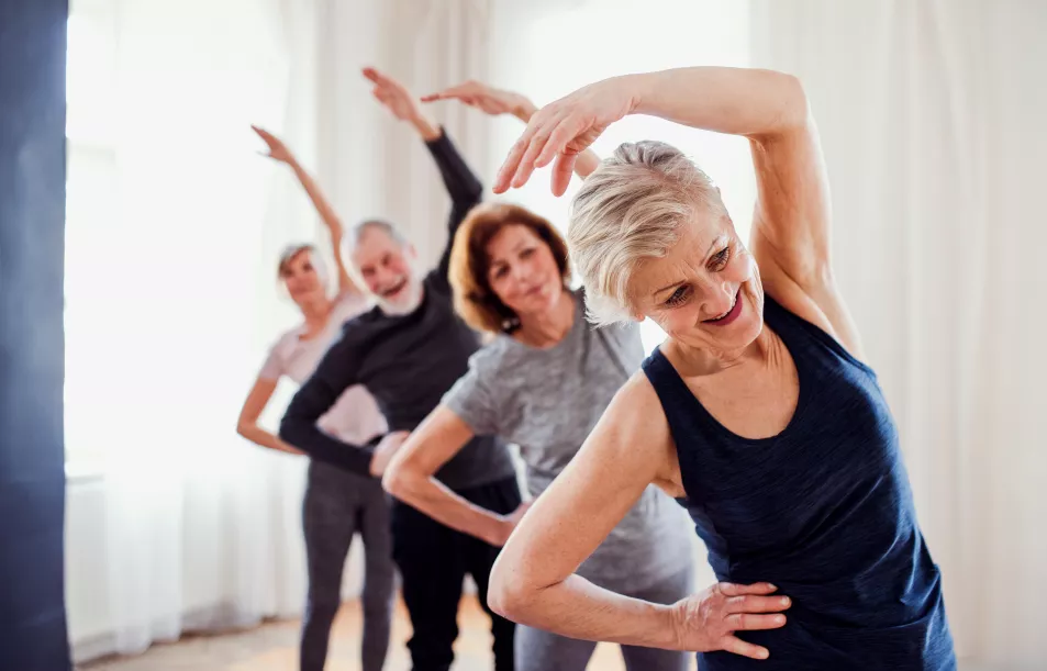 Group of senior people stretching together at a community club