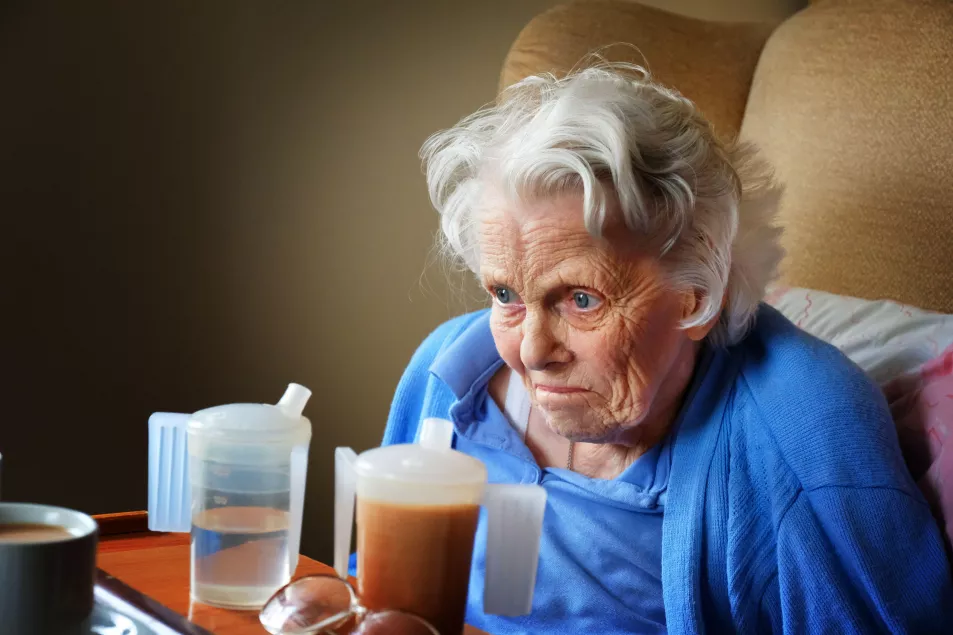 Old woman suffering with dementia looking into the distance 