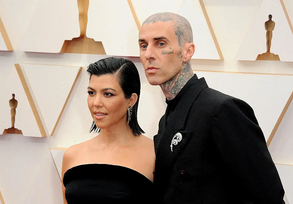 Kourtney Kardashian and Travis Barker pose on red carpet