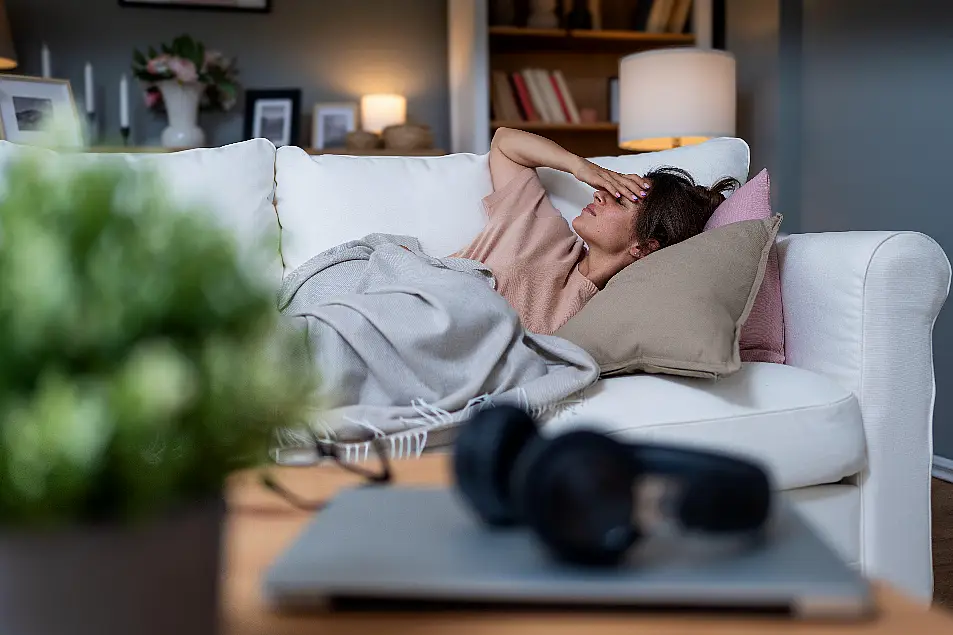 Exhausted woman laying on a sofa