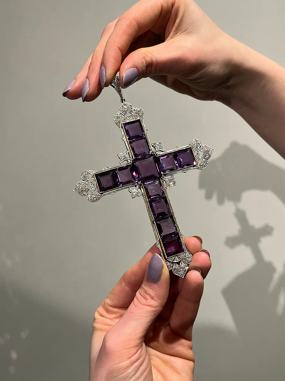 Close up of amethyst and diamond cross necklace