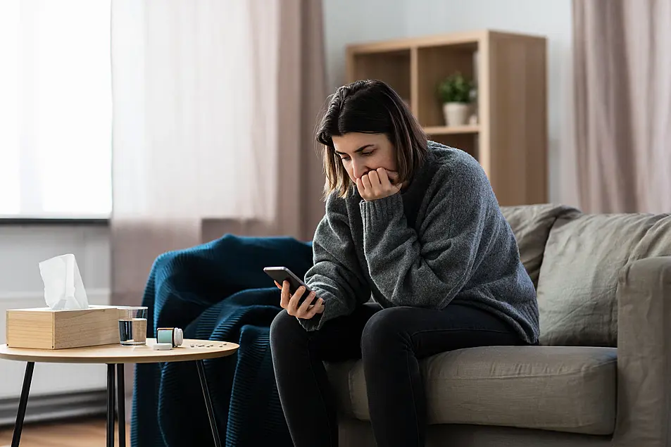 Stressed woman looking at her phone