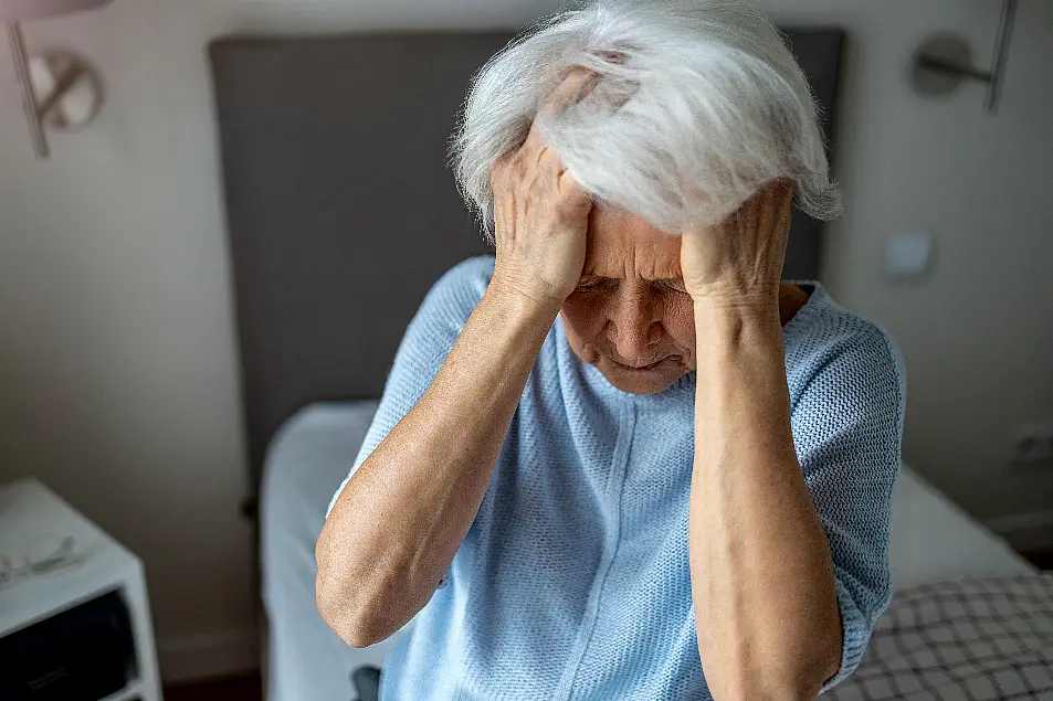 Senior woman covering face with her hands