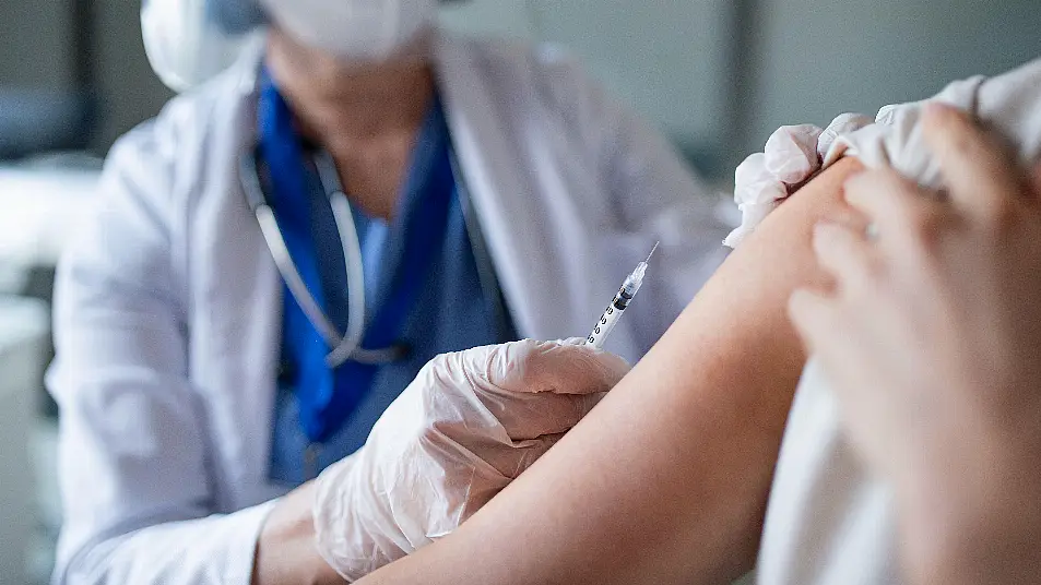 Unrecognisable woman getting vaccinated in hospital