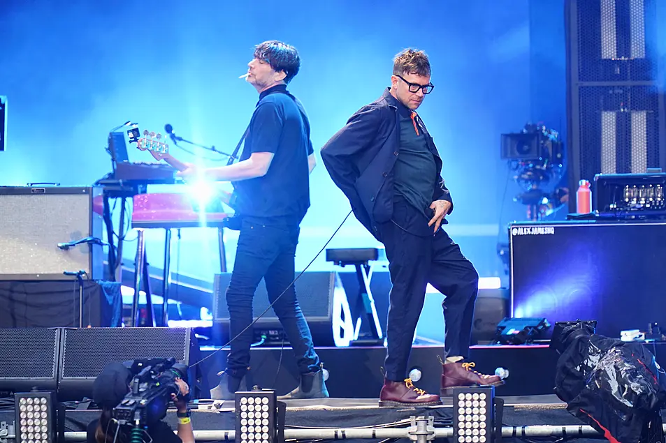 Alex James (L) and Damon Albarn of Blur performing on stage at Wembley Stadium in London in 2023.