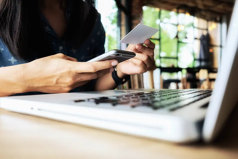 Woman puts in credit card details whilst online shopping 