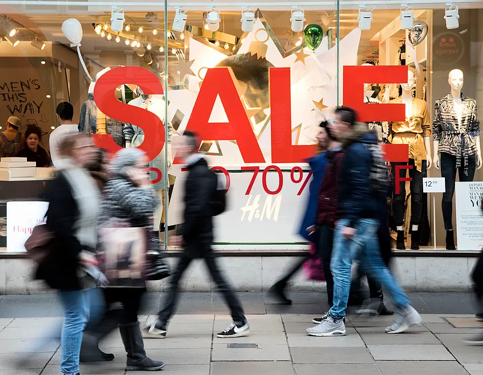 People passing sales signs in Oxford Street.