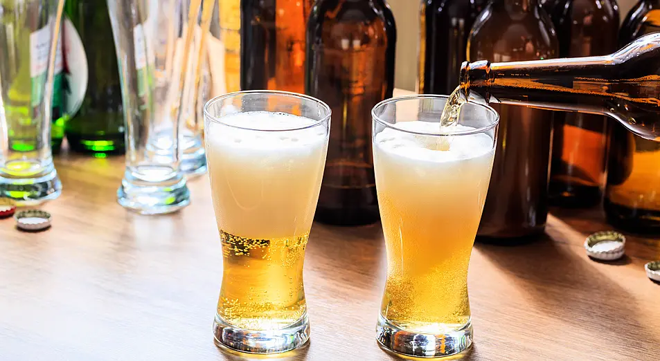 Two glasses of beer on a table in a pub 