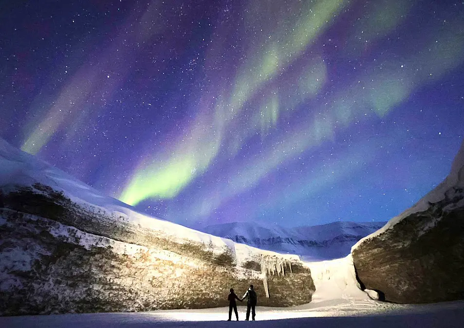 Bryony and Henrik Hegard looking up at the Northern Lights