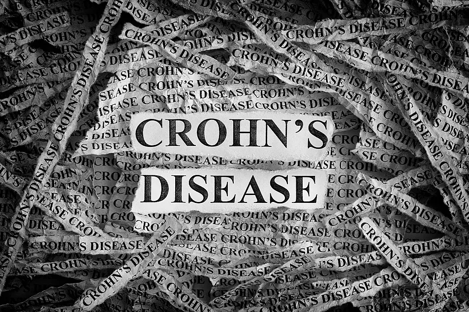  Torn pieces of paper with the words Crohn's Disease