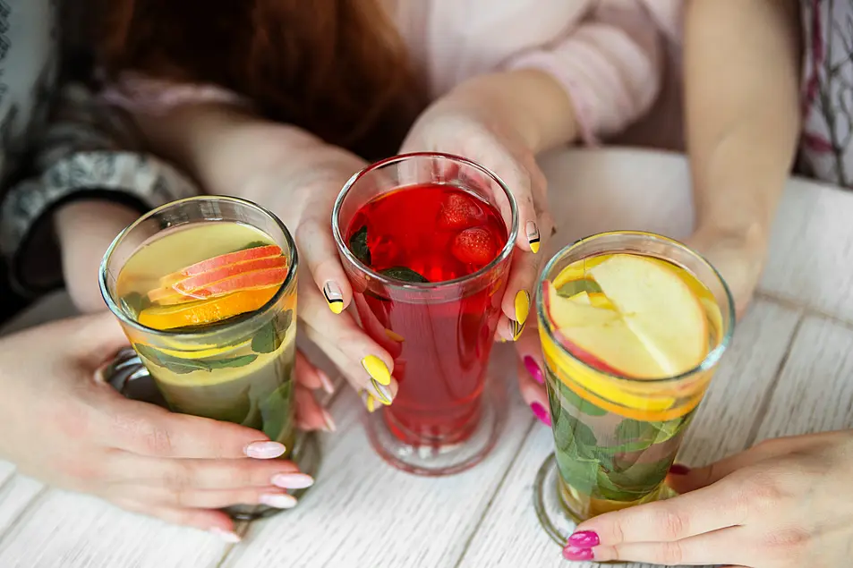 Three woman holding a variety of mocktails 