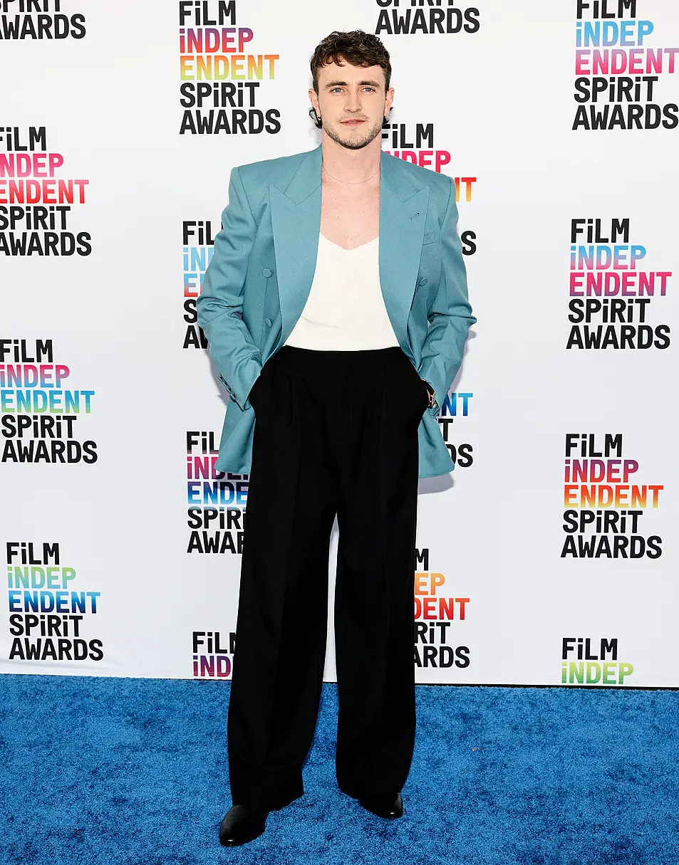 Paul Mescal poses in vest and blue blazer on red carpet