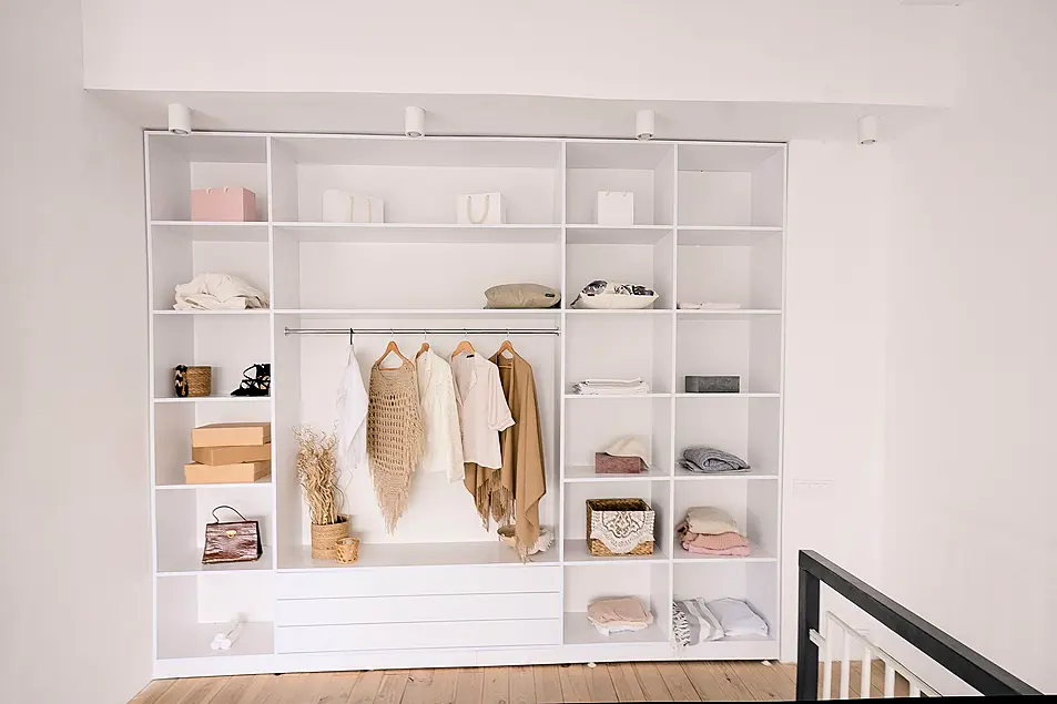 Built-in open wardrobe with lighting and zoning sections for clothing and accessories