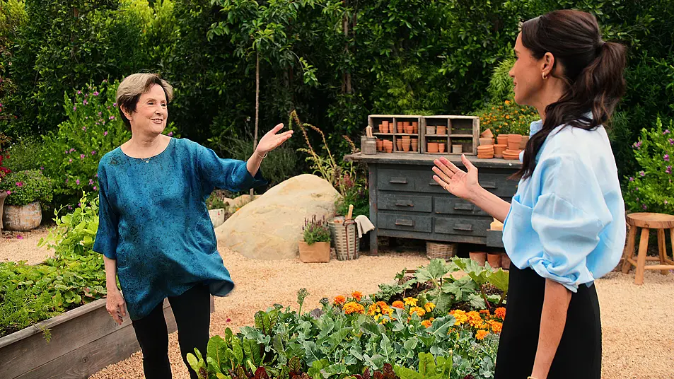 Alice Waters with Meghan in a garden in an episode from the show 