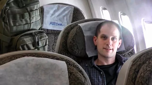 Evan Gershkovich sits inside an aeroplane at an airport outside Moscow