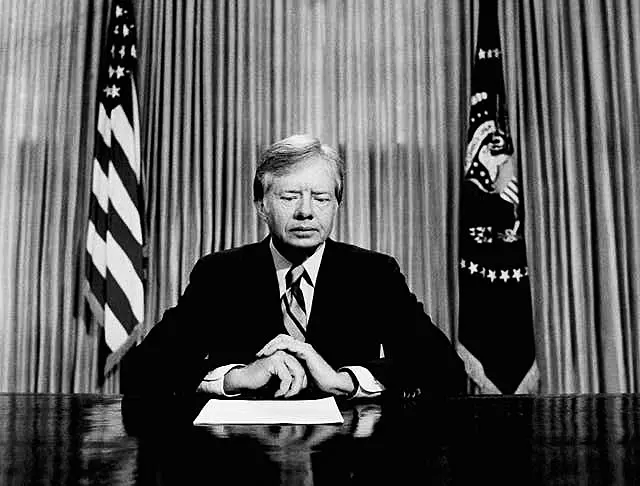 Former president Jimmy Carter prepares to make a national television address from the Oval Office at the White House in April 1980