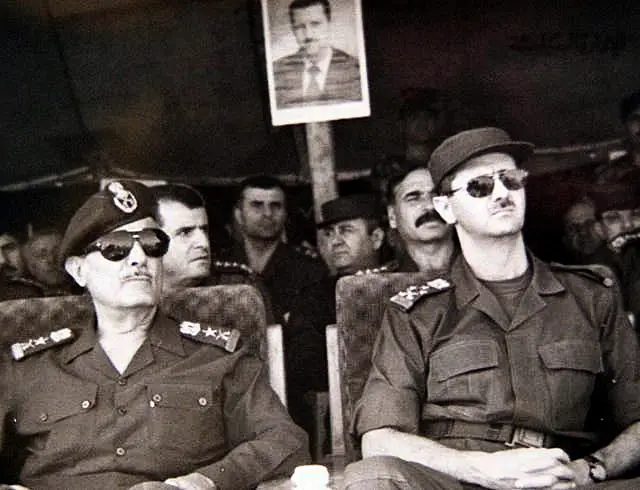 Black and white photo of Bashar Assad in military gear