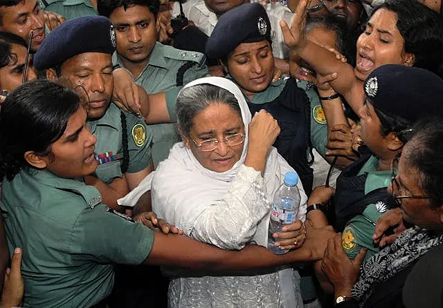 Police escort former Bangladeshi prime minister Sheikh Hasina (Abu Taher Khokon/AP)