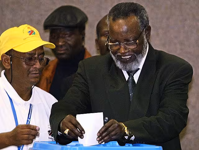 Sam Nujoma casting his vote as an unidentified election worker looks on
