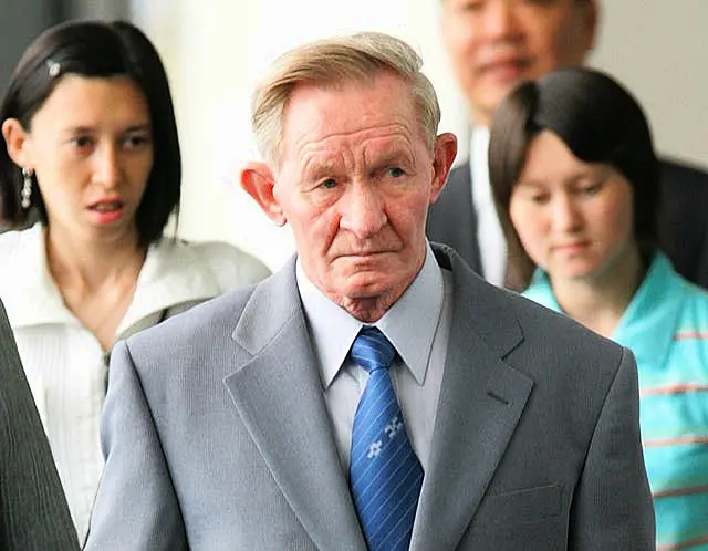 Former US army deserter to North Korea, Charles Jenkins, together with his daughters Mika, rear left, and Brinda at Narita International Airport, Japan, on June 14, 2005 