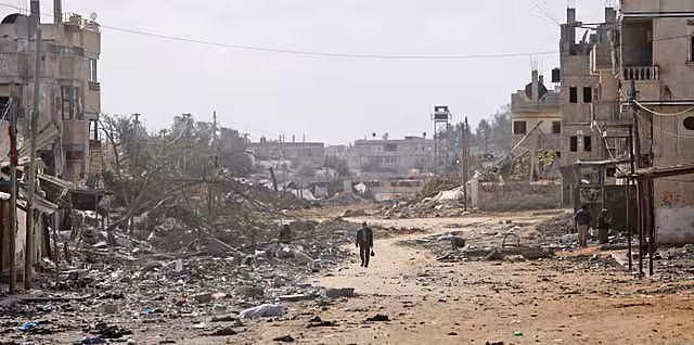 A man walks down a destroyed street in Rafah 