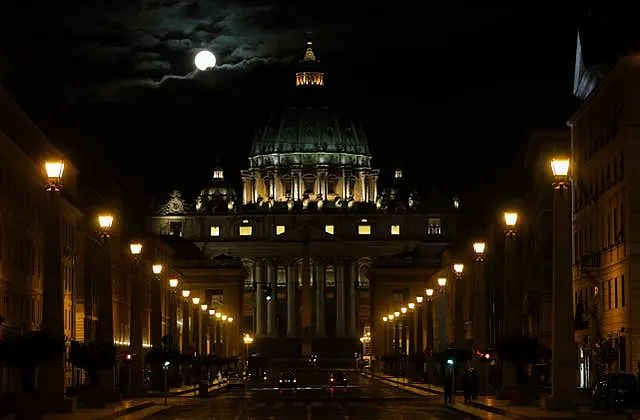 The fool moon is seen above St Peter’s Basilica at the Vatican