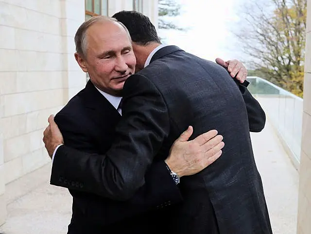 Bashar Assad embracing Vladimir Putin