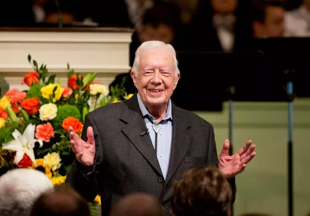 Jimmy Carter smiles and gestures with his hands