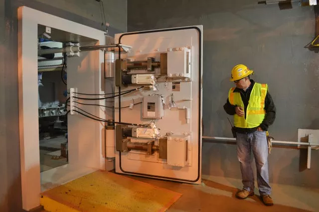 A worker at the Blue Grass Chemical Agent Pilot Plant looks at a blast door inside the facility