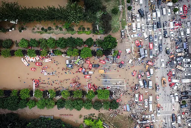 Rescue workers deploy life rafts for evacuating residents during floods in Zhuozhou in northern China’s Hebei province