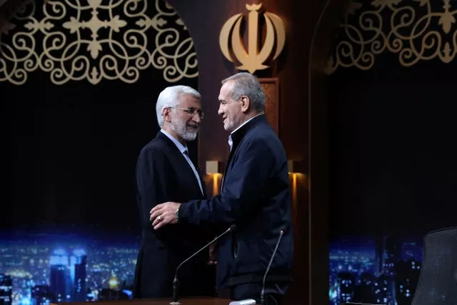 Iranian presidential candidate Saeed Jalili, left, a hard-line former nuclear negotiator, and reformist candidate Masoud Pezeshkian greet one another at the conclusion of a TV debate
