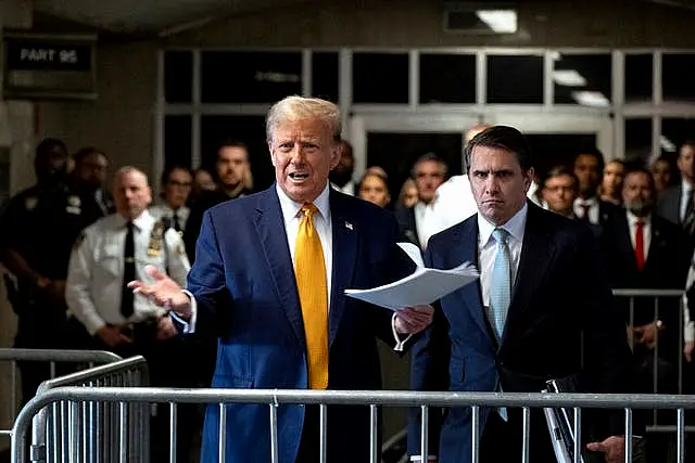 Donald Trump speaks before the start of proceedings in his trial at Manhattan Criminal Court in New York