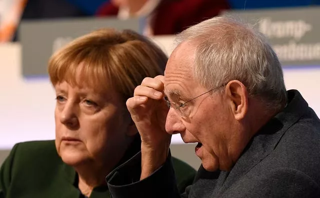 Then-German chancellor Angela Merkel, left, and German finance minister Wolfgang Schaeuble at the general party conference of the Christian Democratic Union, CDU, in Essen, Germany, in 2016