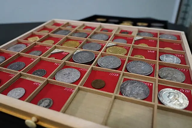 Coins from L.E Bruun’s collection on display on a wooden tray in Zealand, Denmark