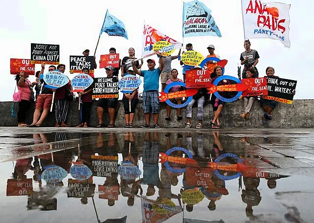 Protesters display placards and shout slogans in a protest against China over its coastguards’ alleged seizure of fish caught by Filipino fishermen near the contested Scarborough Shoal in 2018 