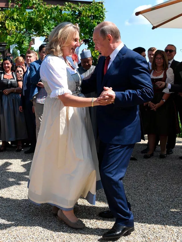 Russian President Vladimir Putin dances with then Austrian foreign minister Karin Kneissl as he attends the wedding of Ms Kneissl and Austrian businessman Wolfgang Meilinger in Gamlitz, southern Austria, on August 18 2018 