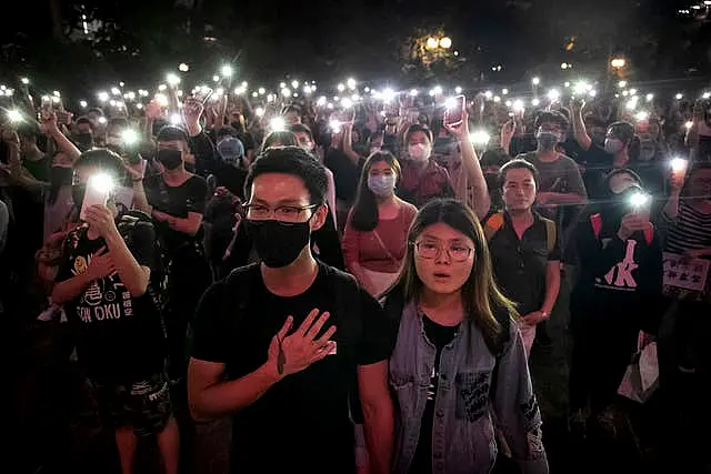 Demonstrators hold their phones aloft as they sing Glory To Hong Kong during a rally in 2019