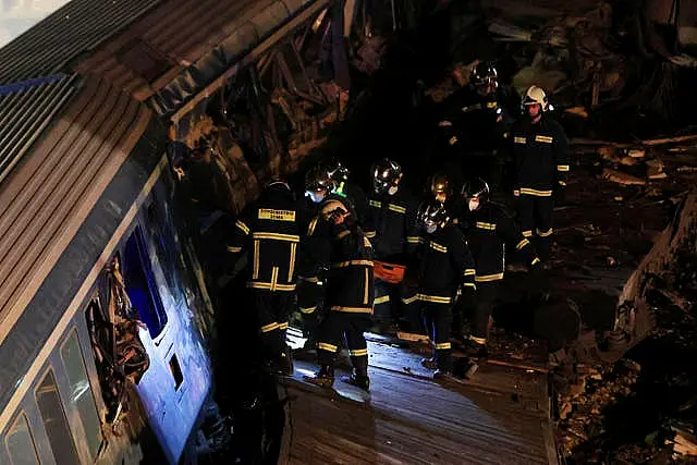 Firefighters operate after a collision in Tempe near Larissa city, Greece early Wednesday, March 1, 2023