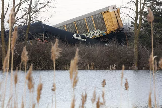 Multiple cars of a Norfolk Southern train lie on the ground after derailing in Ohio