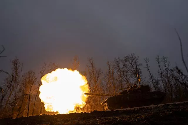 A Ukrainian tank towards fires towards Russian positions at the frontline near Bakhmut