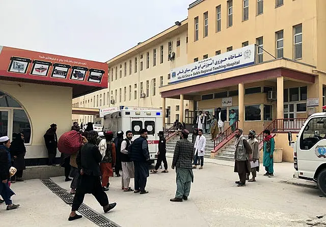 People stand outside a hospital after the blast