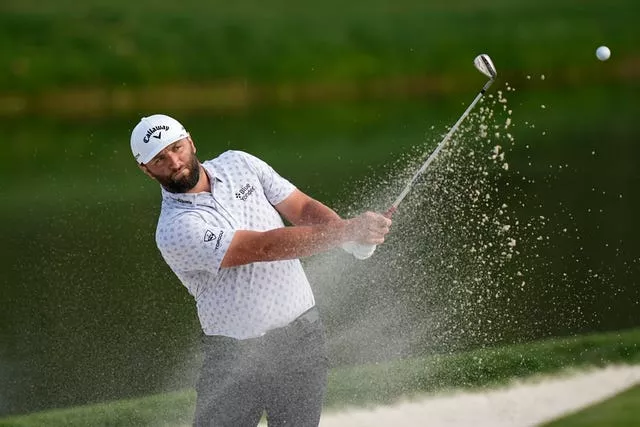 Jon Rahm plays out of a bunker