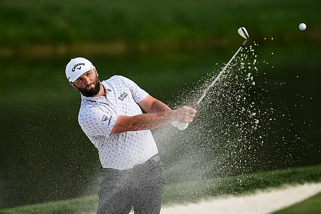 Jon Rahm plays out of a bunker