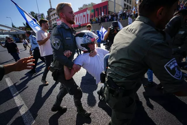 Israeli border police officers disperse demonstrators blocking a motorway