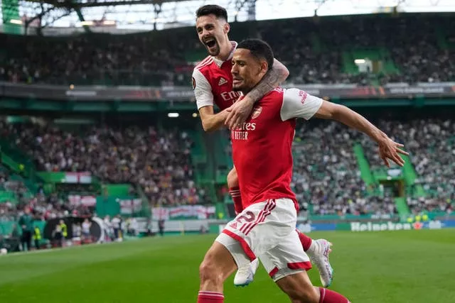 Arsenal’s William Saliba, right, celebrates with his team-mate Fabio Vieira 