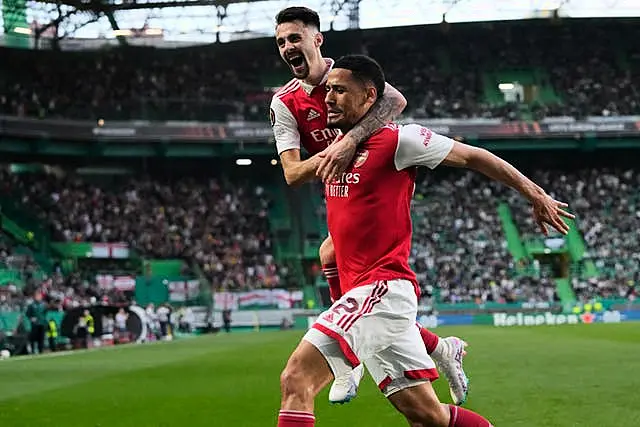 Arsenal’s William Saliba, right, celebrates with his team-mate Fabio Vieira 