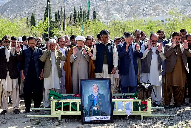 Relatives and mourners attend the funeral prayer of female field hockey player Shahida Raza